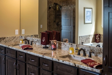 closeup of double vanity with darker finish cabinetry