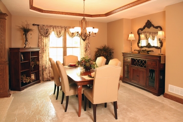 formal dining room with recessed ceiling