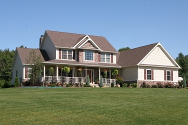 large custom home with large porch by gatliff custom homes