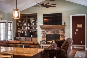 living room view of fireplace and built in shelving