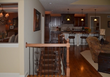 view of lower level stairway from first floor custom home