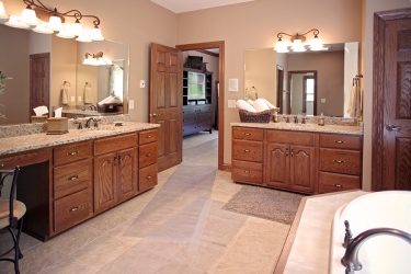 master bathroom with double vanity and garden tub