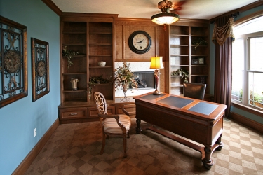 office or den with built in shelves and window view