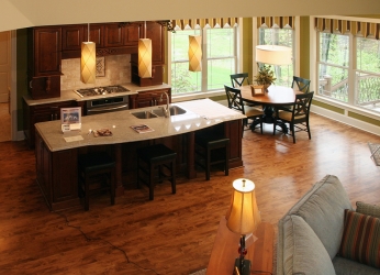 view of custom kitchen from stairway landing by gatliff custom builders