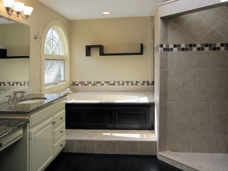 luxury bathroom featuring tile and elevated tub