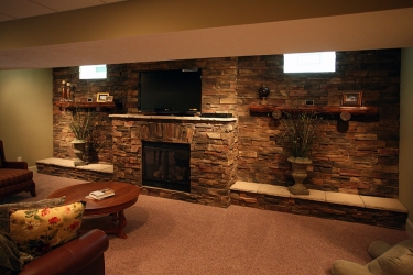 view of fireplace and stonework in lower level rec area