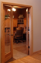 view of custom study through double doors with glass