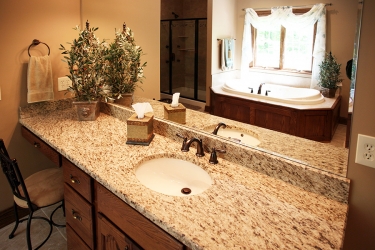 vanity and mirror reflection of garden tub and shower