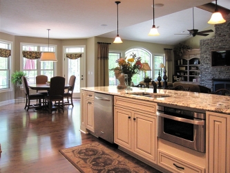 white kitchen with view to dining area with plenty of natural lighting